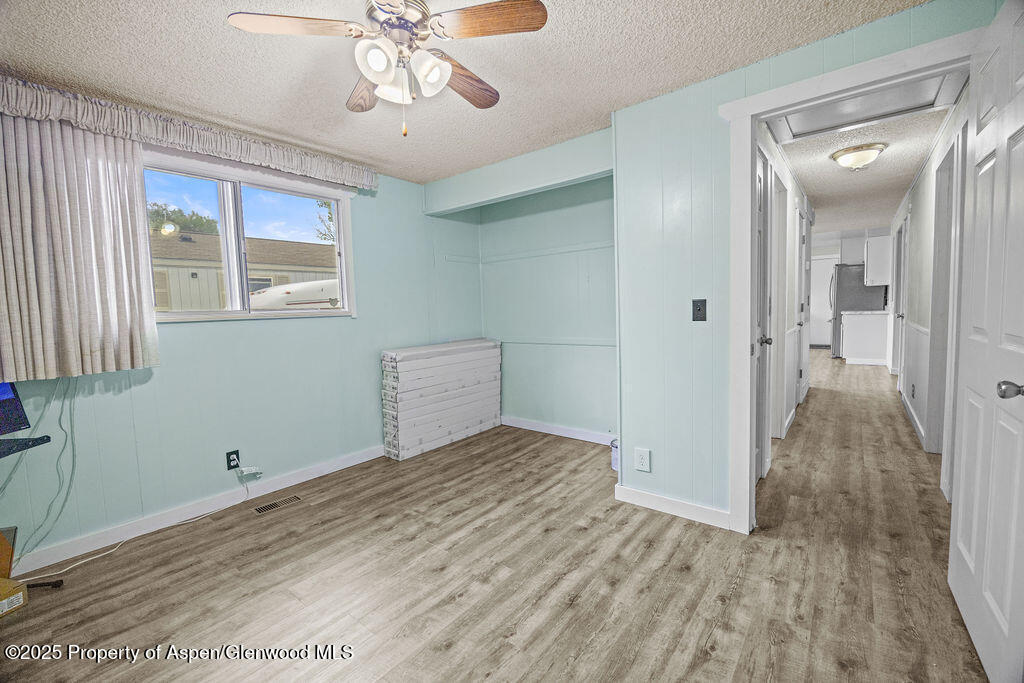 562 Rose Street Craig, CO 81625 - Photo 29 of 59 a view of empty room with wooden floor