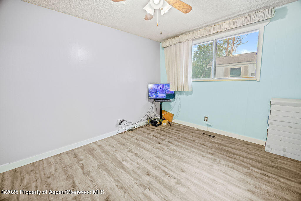562 Rose Street Craig, CO 81625 - Photo 30 of 59 a view of a room with a window and wooden floor