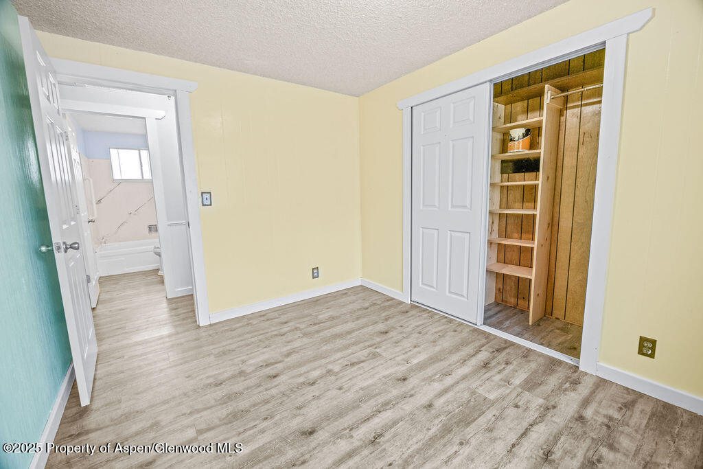 562 Rose Street Craig, CO 81625 - Photo 33 of 59 an empty room with wooden floor and entrance