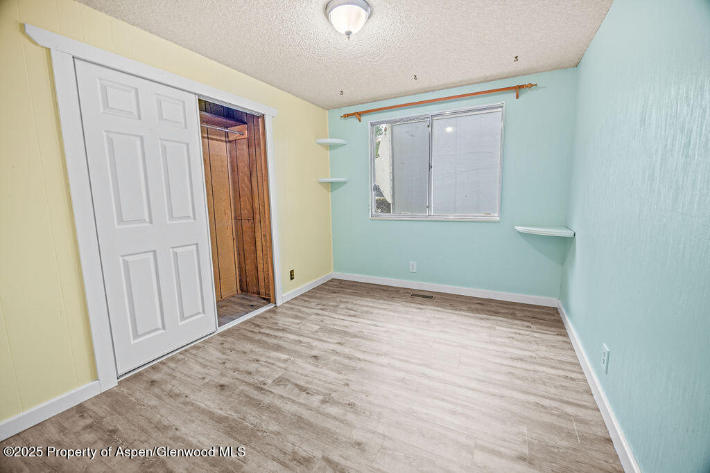562 Rose Street Craig, CO 81625 - Photo 34 of 59 a view of an empty room with wooden floor and a window