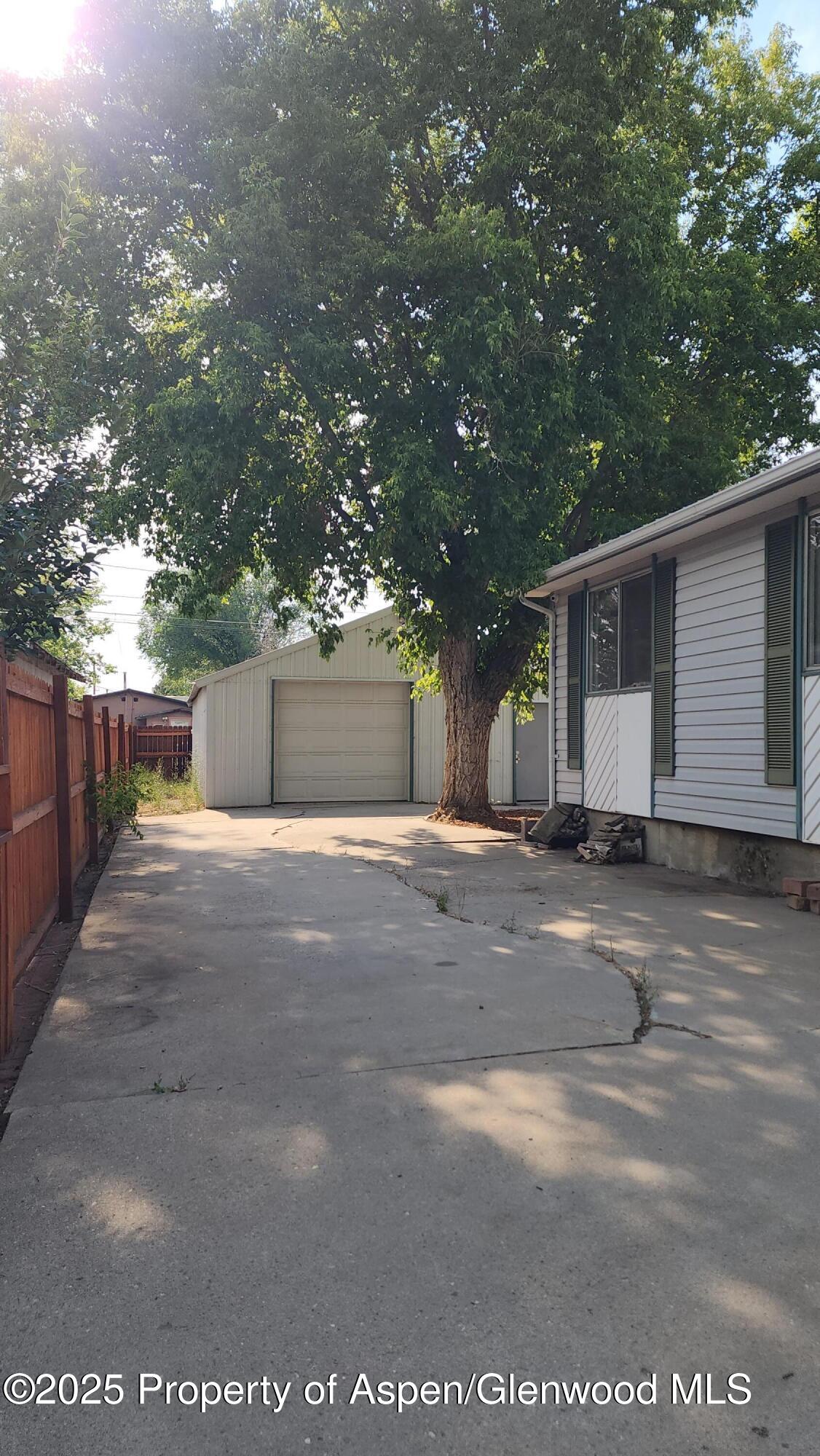 562 Rose Street Craig, CO 81625 - Photo 37 of 59 a view of a house with a yard and garage
