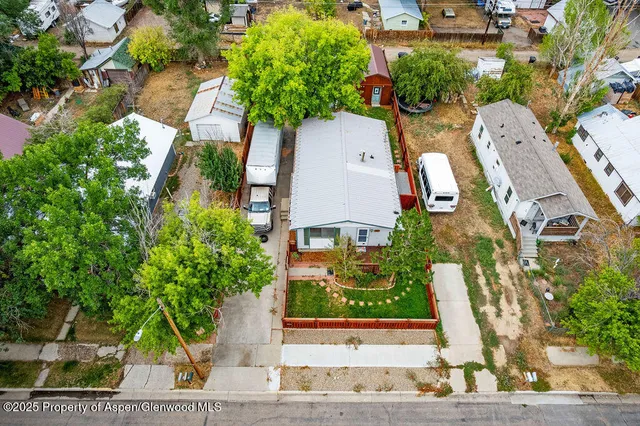 an aerial view of a house with garden space and street view