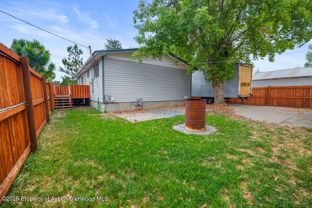562 Rose Street Craig, CO 81625 - Photo 55 of 59 a front view of a house with a garden and yard