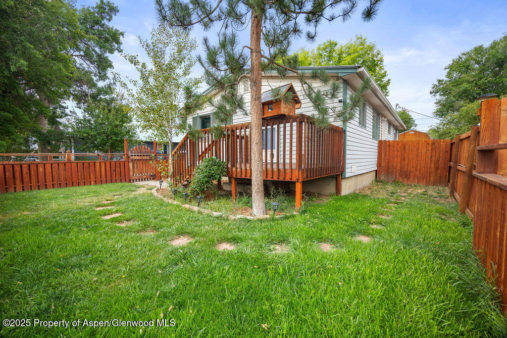 562 Rose Street Craig, CO 81625 - Photo 7 of 59 a view of a house with a yard and deck