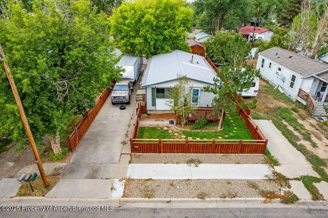 a view of a house with a wooden fence