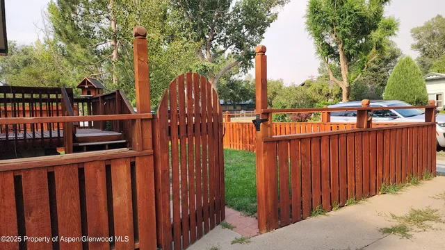 a view of balcony with wooden floor and fence