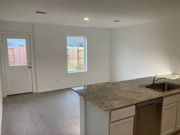 a kitchen with granite countertop sink vanity and granite