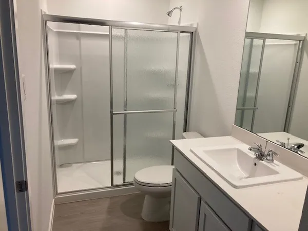 a bathroom with a sink toilet and shower