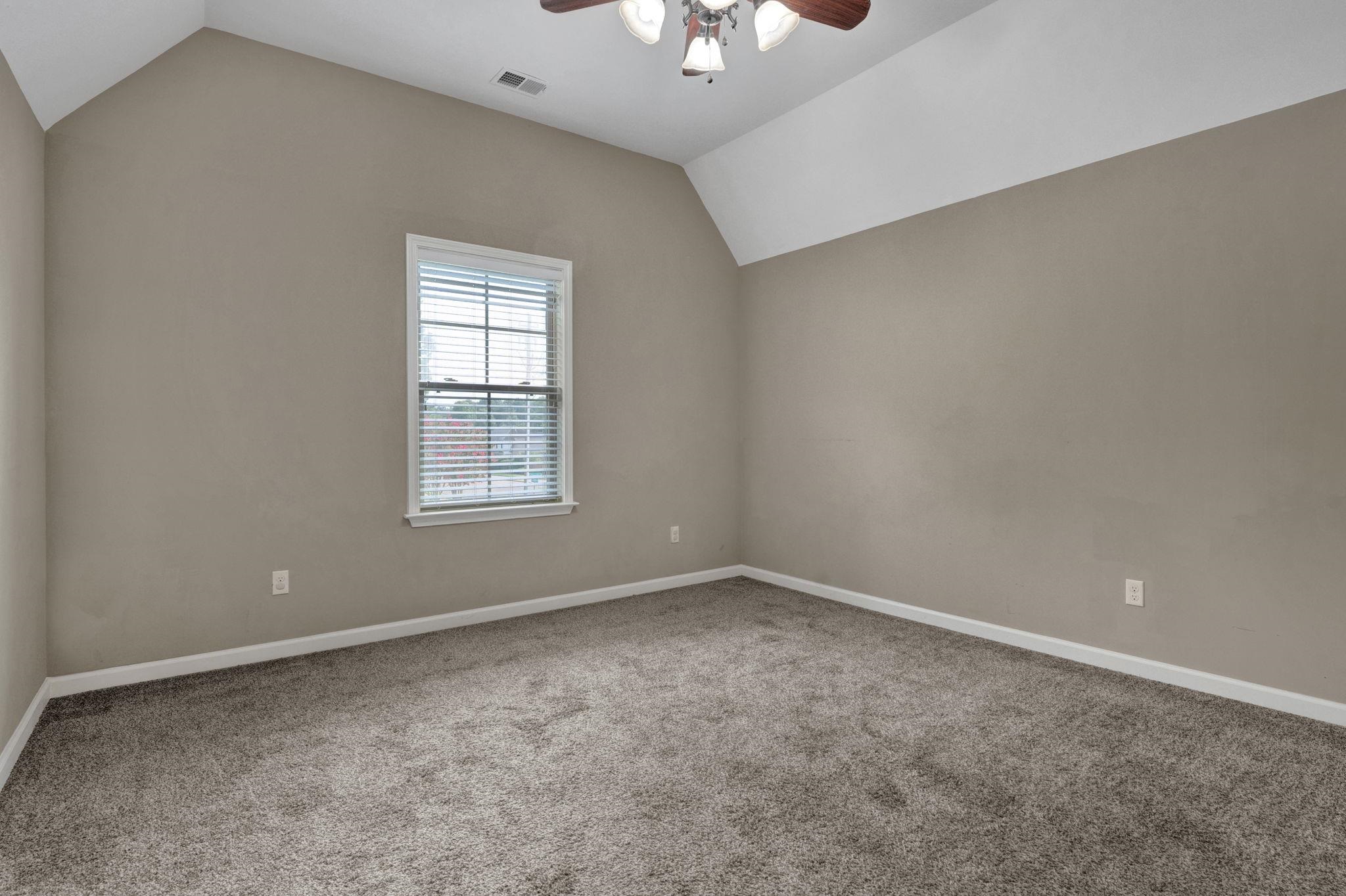 314 Estanaula Road Collierville, TN 38017 - Photo 20 of 29 a view of an empty room with window and a ceiling fan