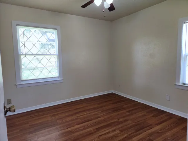 wooden floor in an empty room with a window