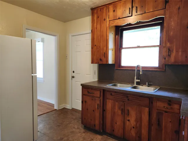a kitchen with a window a sink and a window