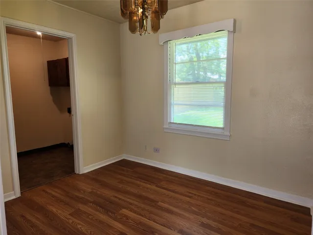 a view of a livingroom with wooden floor and a window