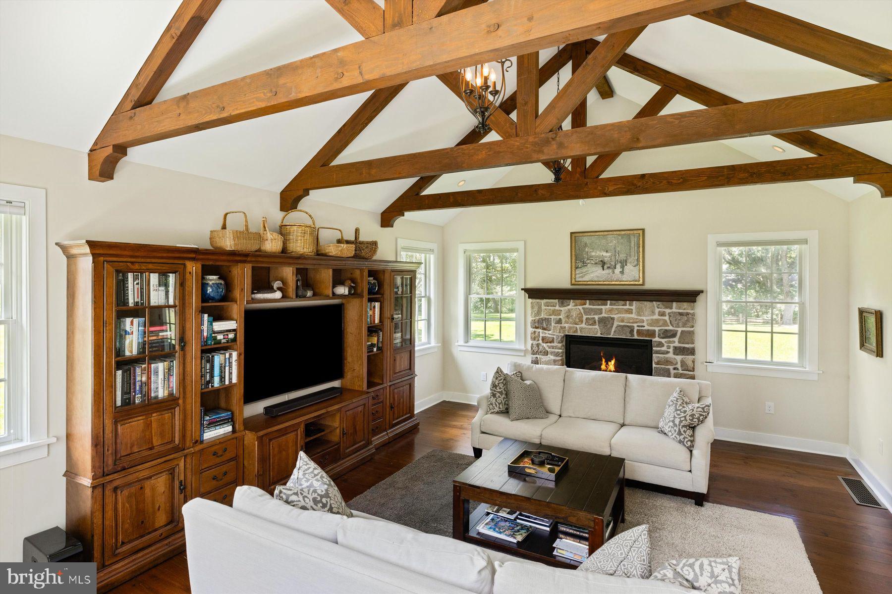 3087 Creamery Road New Hope, PA 18938 - Photo 25 of 68 a living room with furniture a flat screen tv and a floor to ceiling window