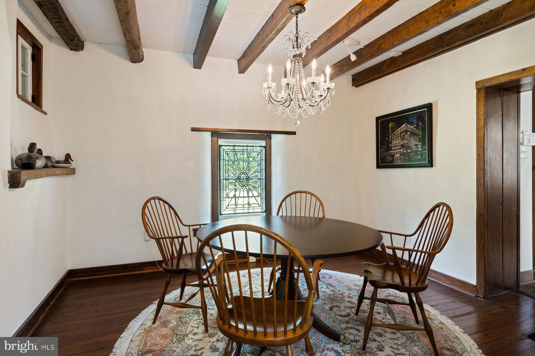 3087 Creamery Road New Hope, PA 18938 - Photo 28 of 68 a view of a dining room with furniture a chandelier and wooden floor