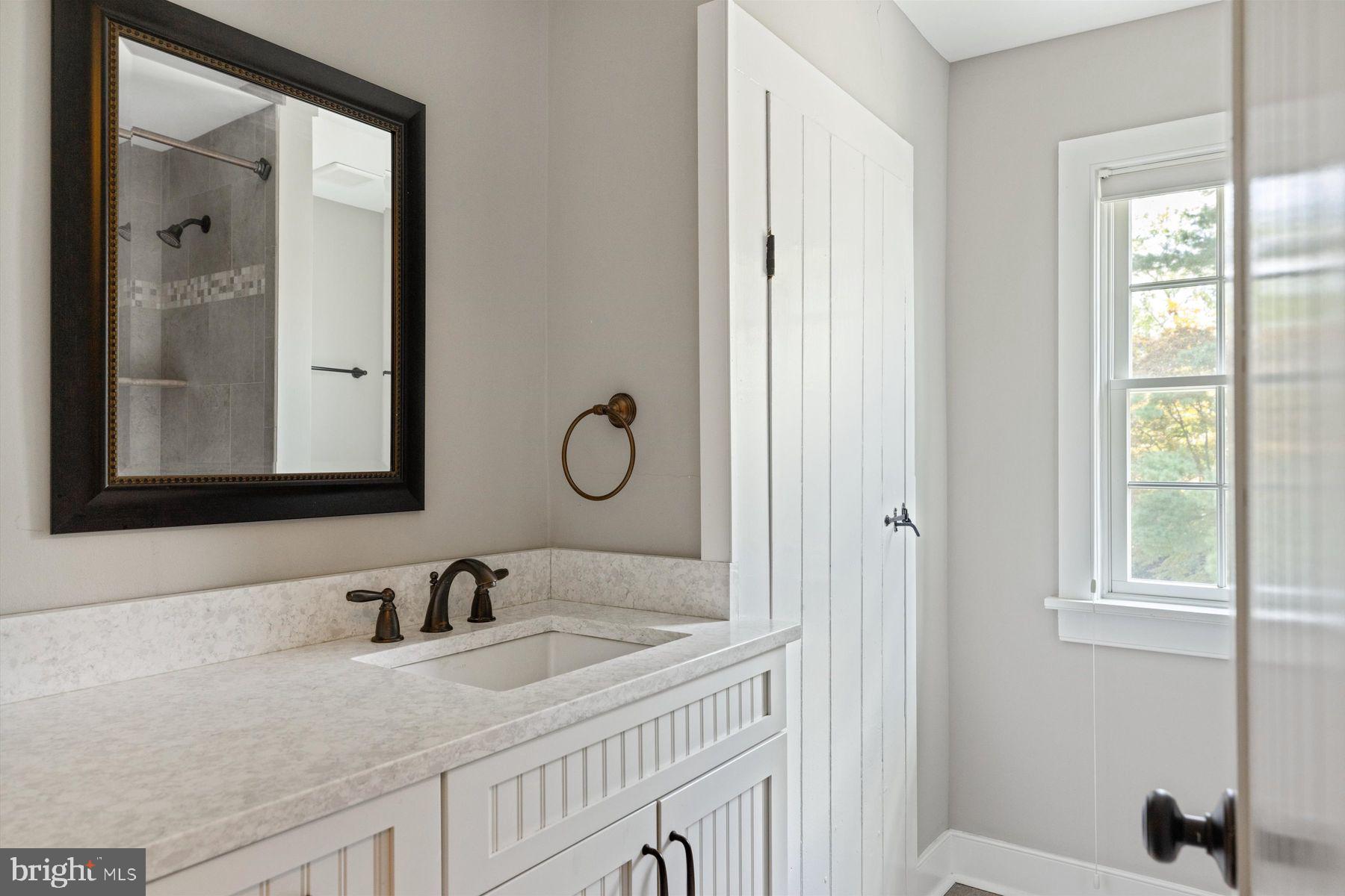 3087 Creamery Road New Hope, PA 18938 - Photo 48 of 68 a bathroom with a granite countertop sink and a mirror