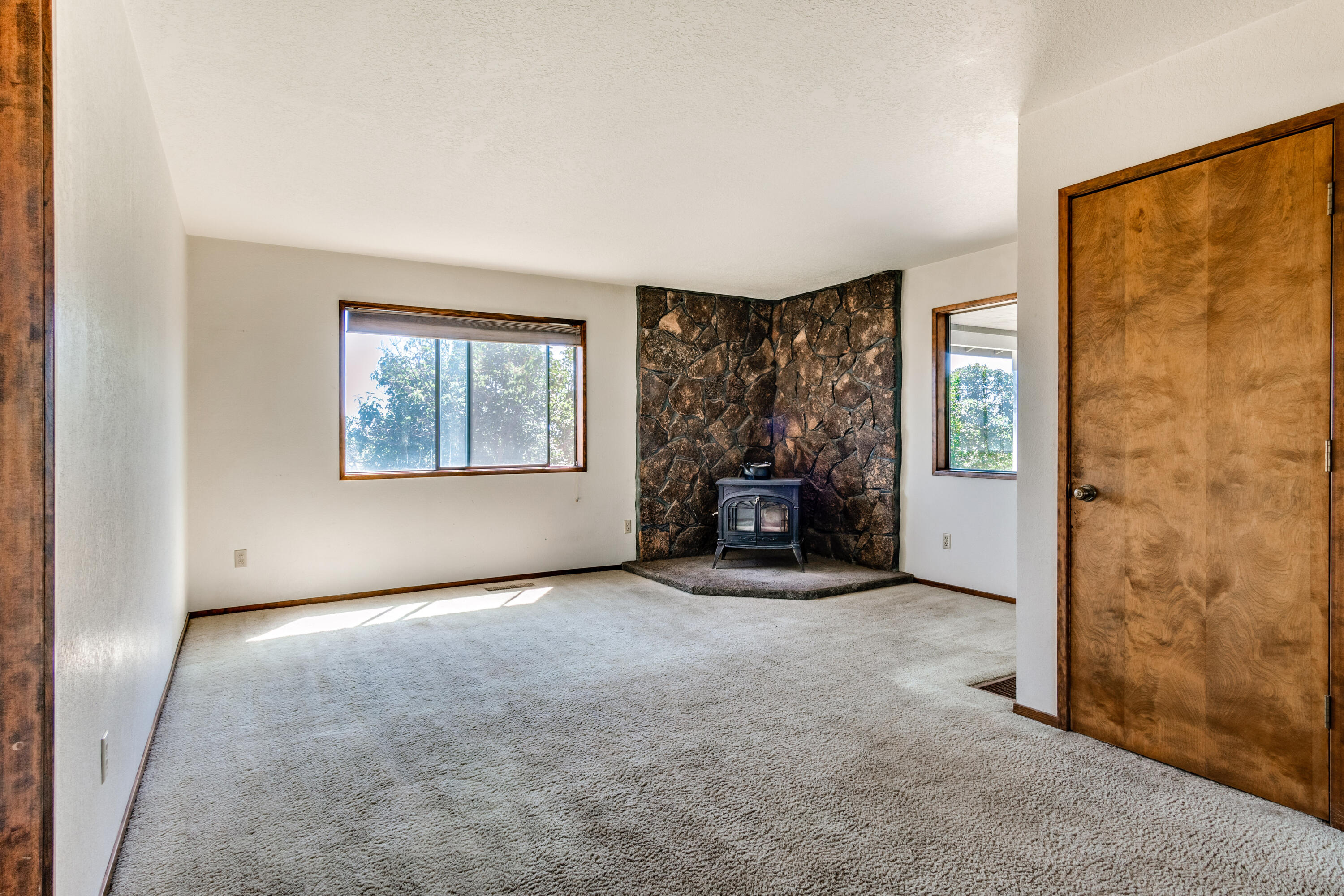 65070 Gerking Market Road Bend, OR 97703 - Photo 16 of 45 Secondary living room off of kitchen with wood stove insert