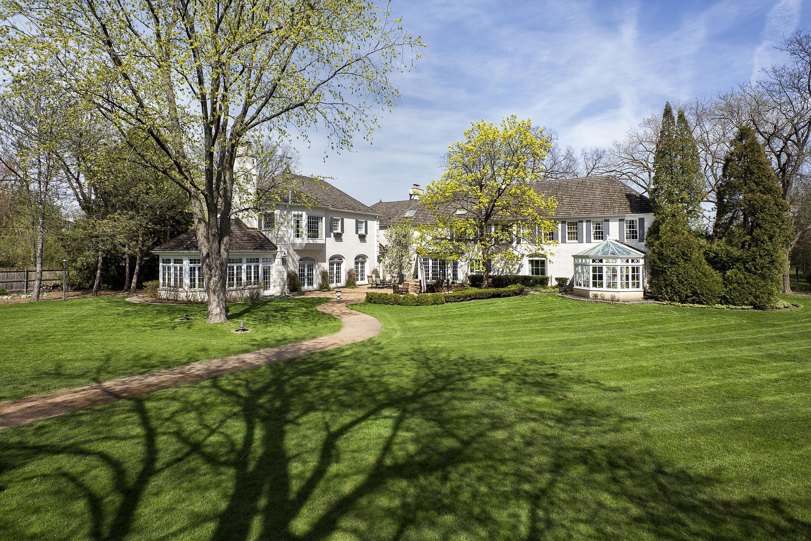 578 Sunset Ridge Road Northfield, IL 60093 - Photo 19 of 21 a view of white house with a big yard and potted plants and large trees