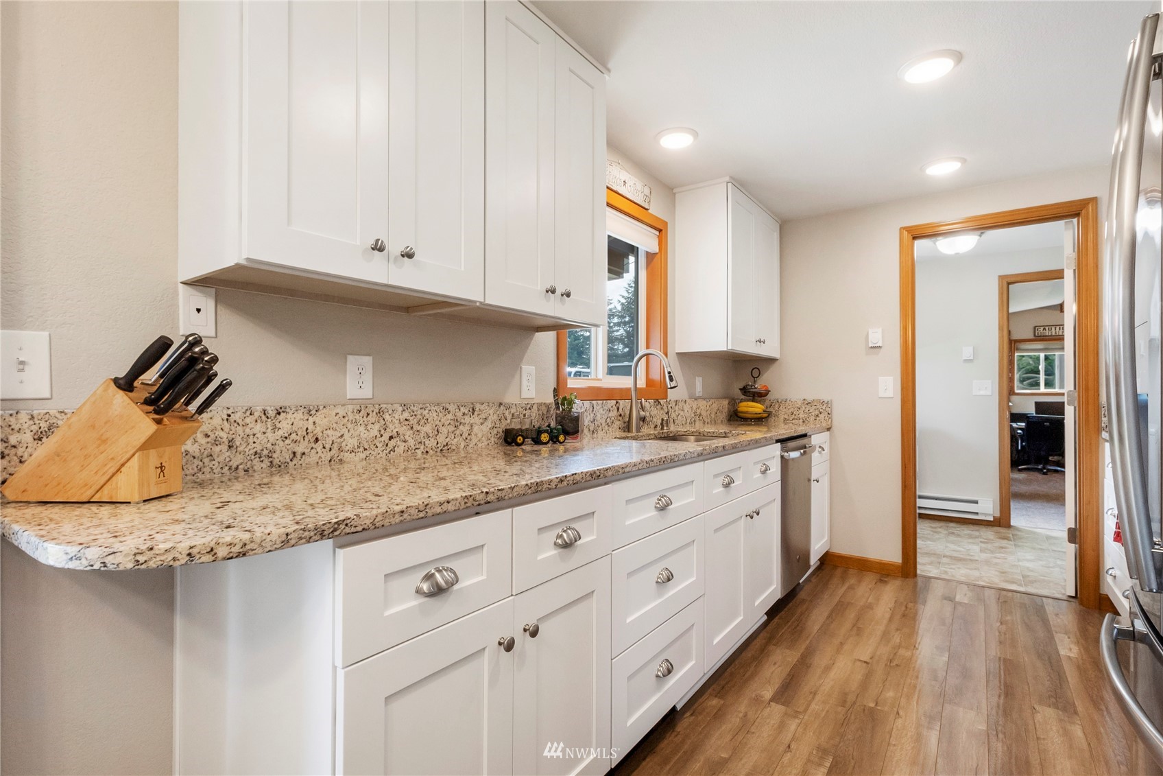 18810 Nutmeg Street Southwest Rochester, WA 98579 - Photo 11 of 26 a kitchen with granite countertop white cabinets and white appliances