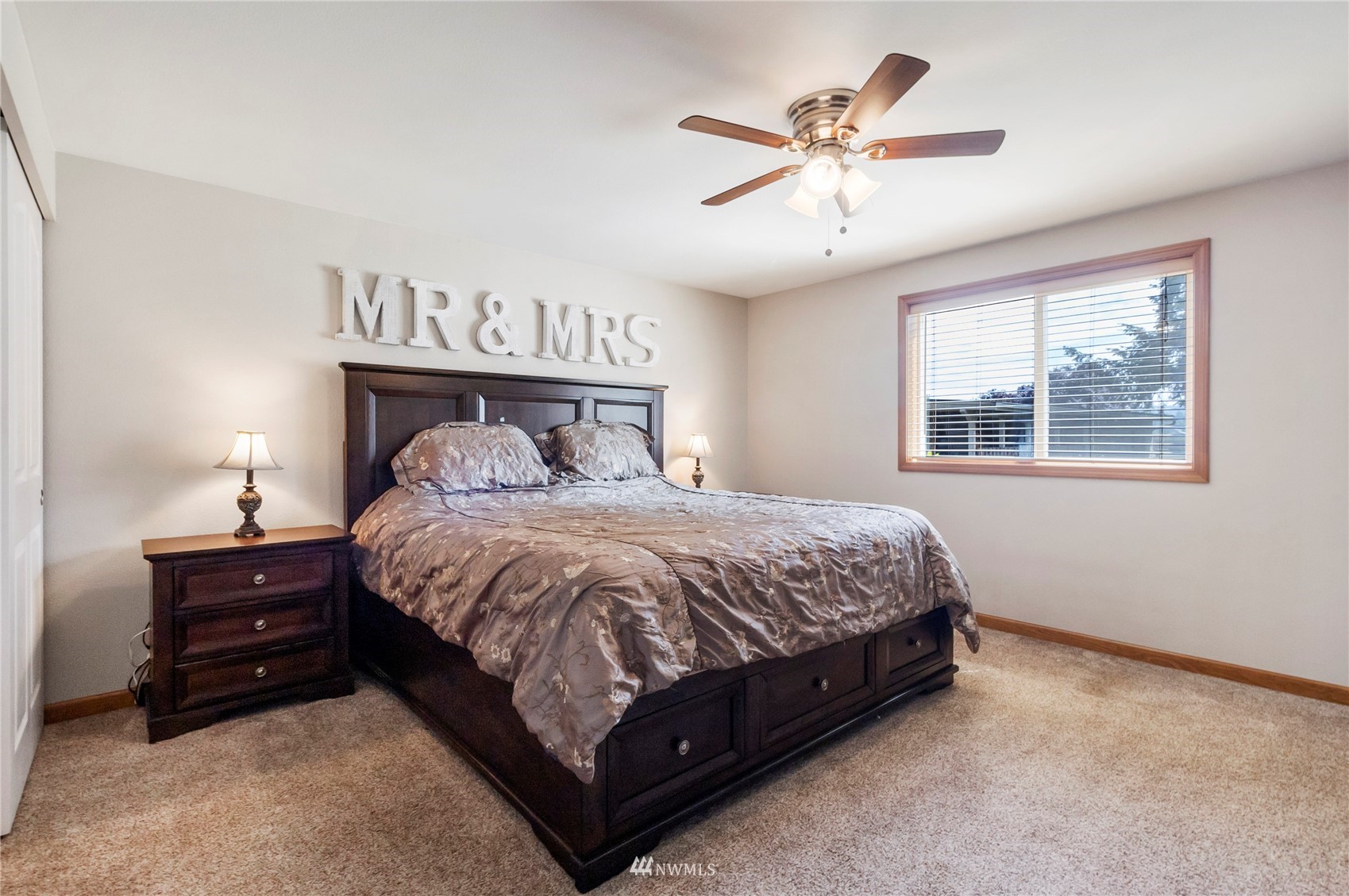 18810 Nutmeg Street Southwest Rochester, WA 98579 - Photo 17 of 26 a spacious bedroom with a bed and a ceiling fan