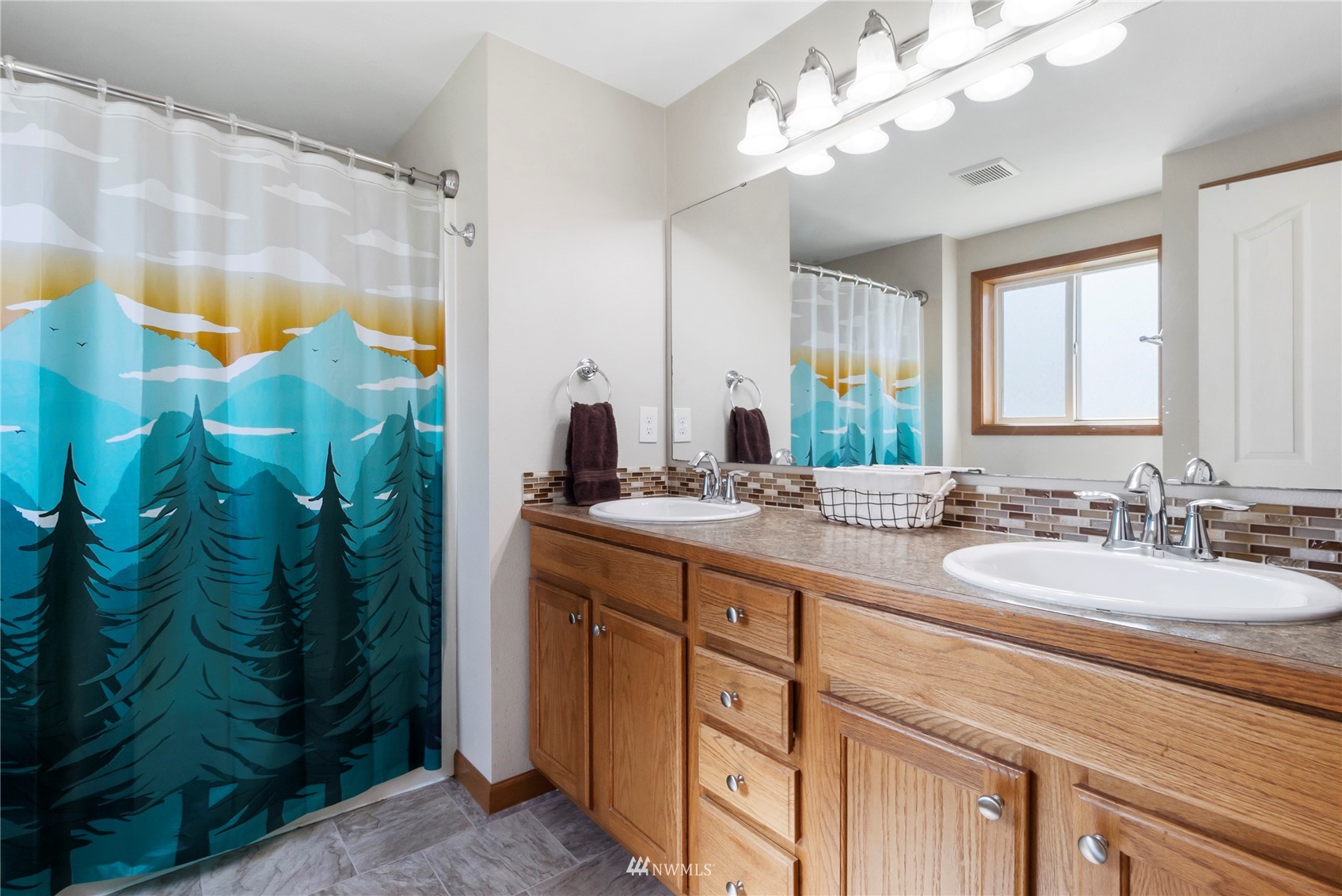 18810 Nutmeg Street Southwest Rochester, WA 98579 - Photo 18 of 26 a bathroom with a double vanity sink mirror and shower