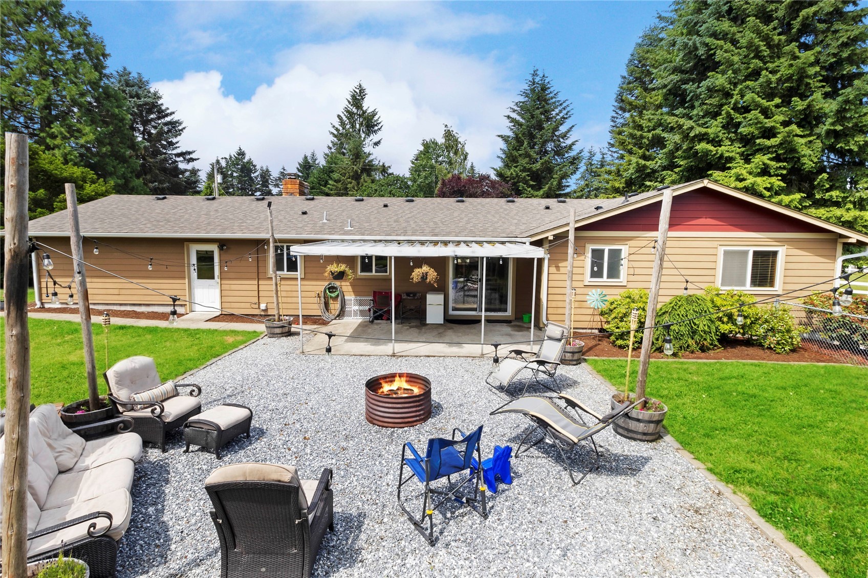 18810 Nutmeg Street Southwest Rochester, WA 98579 - Photo 23 of 26 a view of a house with backyard sitting area and swimming pool