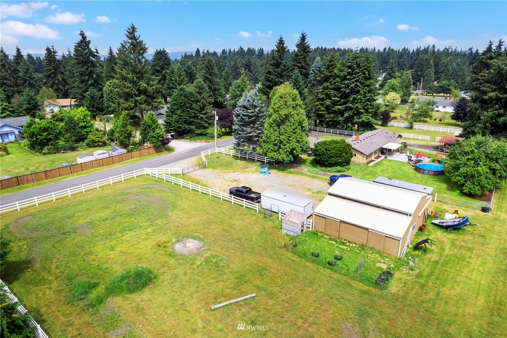 18810 Nutmeg Street Southwest Rochester, WA 98579 - Photo 3 of 26 an aerial view of a house with swimming pool garden and trees in the background