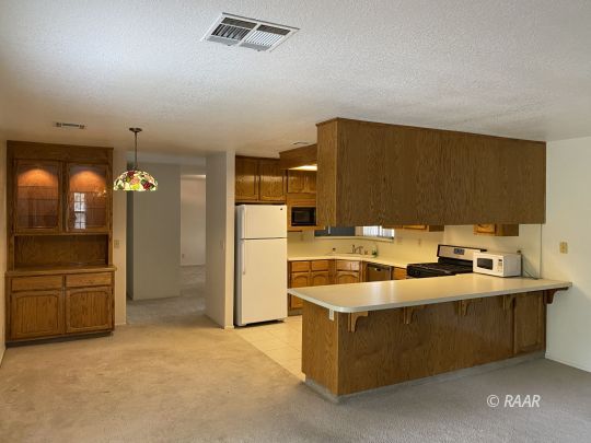 717 North Inyo Street Ridgecrest, CA 93555 - Photo 3 of 26 a view of a kitchen with a sink