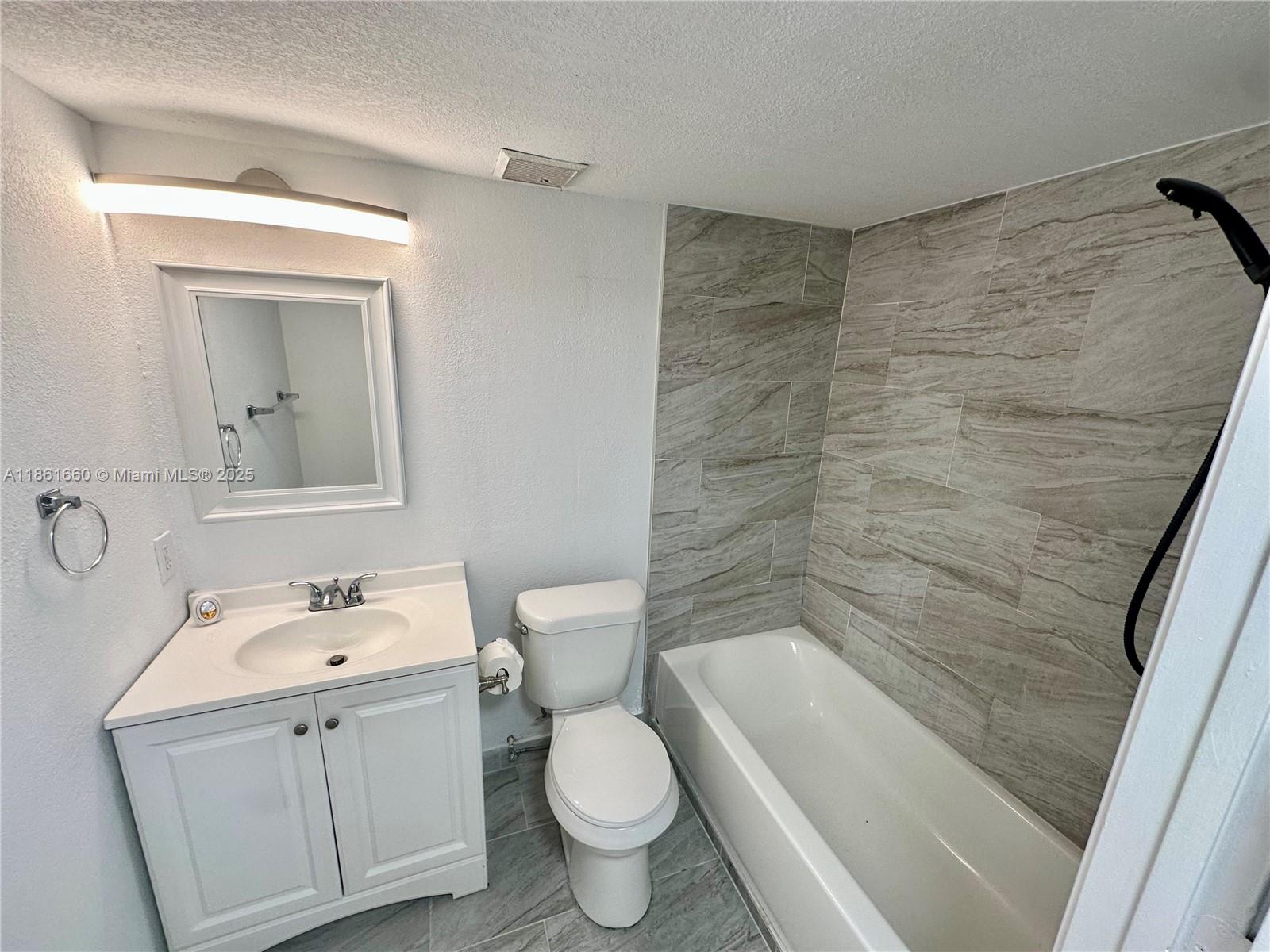 Playland Hollywood, FL 33021 - Photo 12 of 18 a bathroom with a sink a toilet and shower