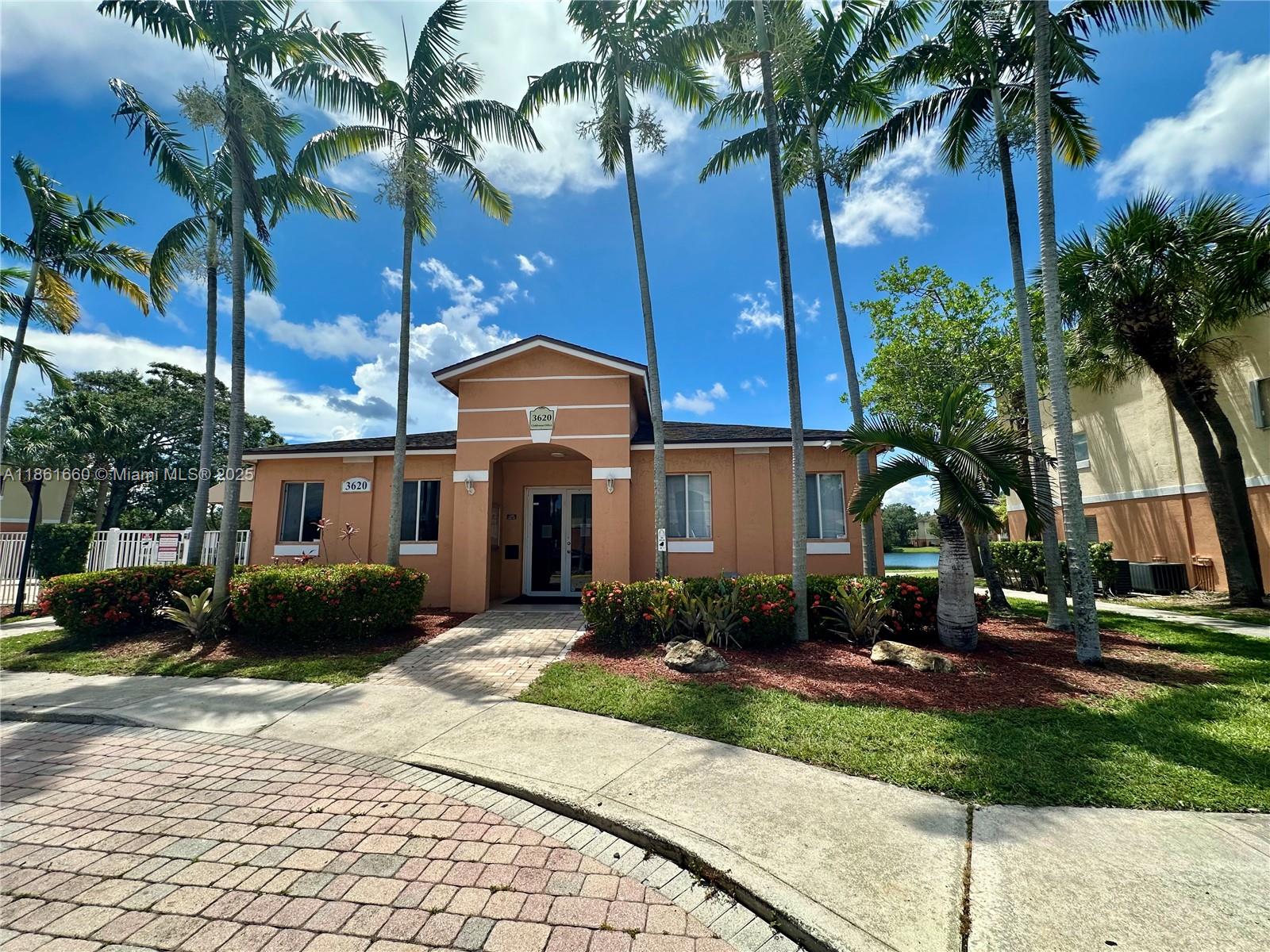 Playland Hollywood, FL 33021 - Photo 13 of 18 a front view of a house with garden