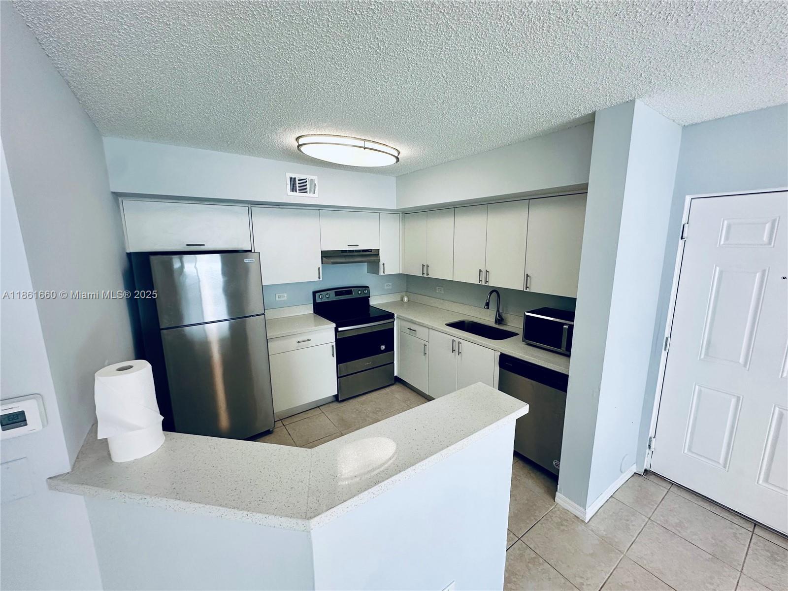 Playland Hollywood, FL 33021 - Photo 5 of 18 a kitchen with stainless steel appliances a refrigerator and a stove top oven