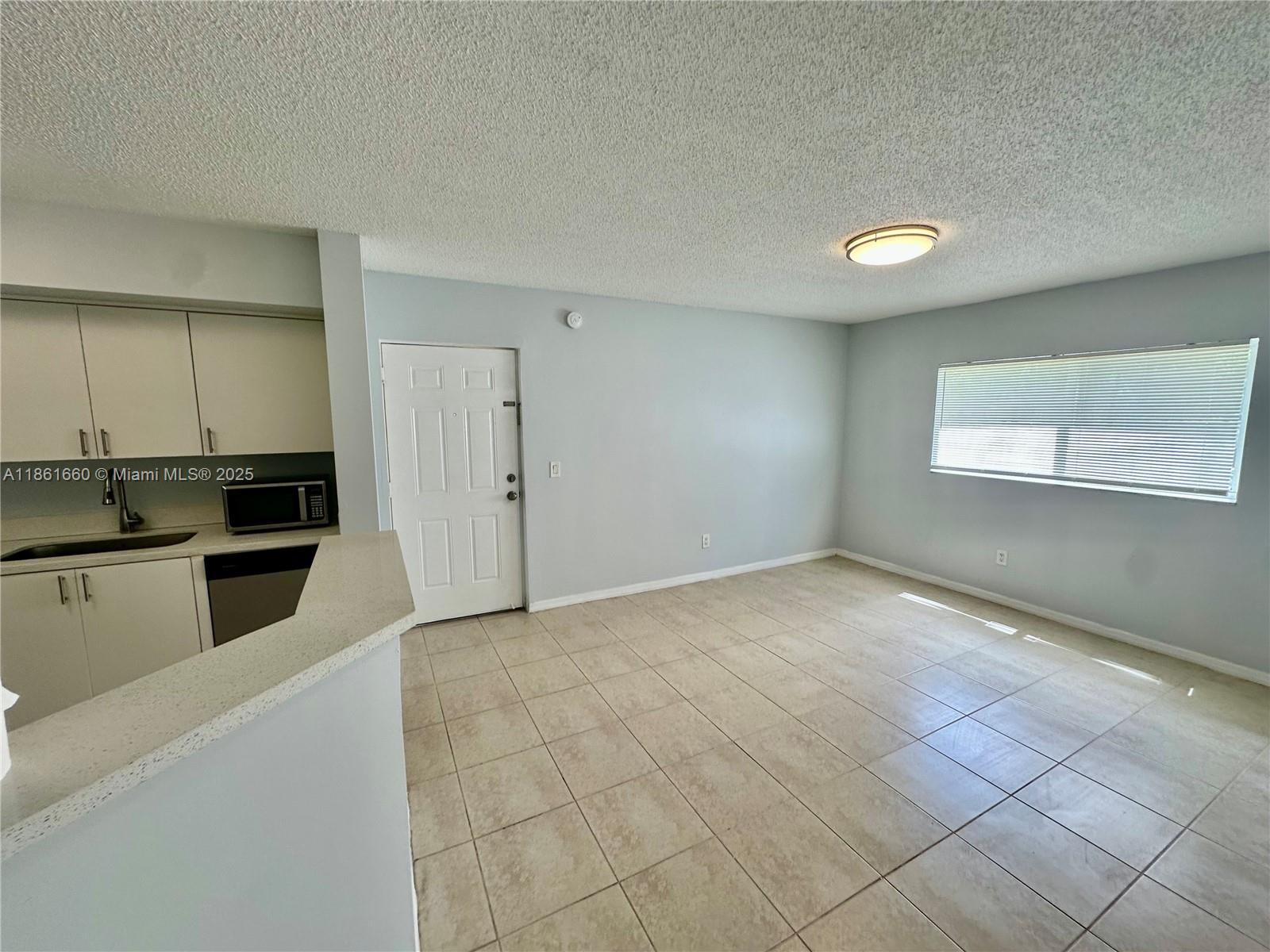 Playland Hollywood, FL 33021 - Photo 6 of 18 a view of a kitchen with microwave and cabinets