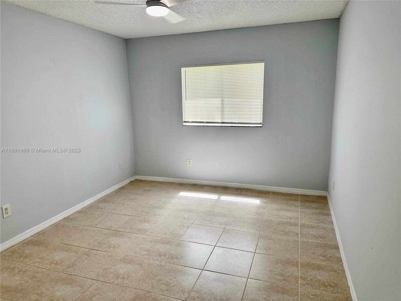 Playland Hollywood, FL 33021 - Photo 7 of 18 an empty room with windows and cabinet
