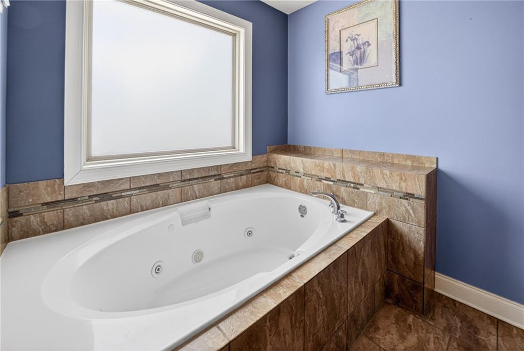 2300 Tucker Mill Road Southwest Conyers, GA 30094 - Photo 23 of 45 a bathroom with a bathtub and a window