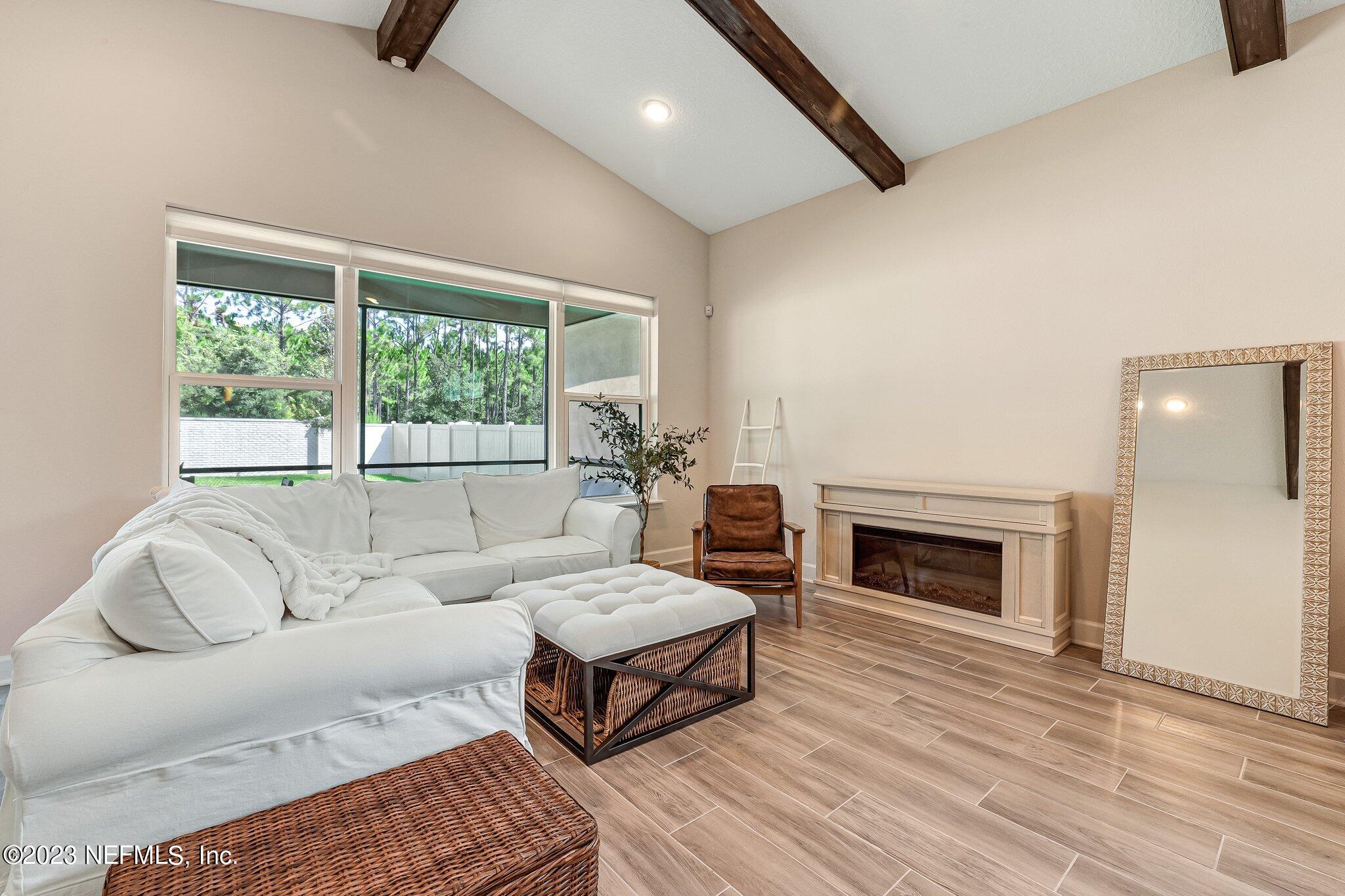 9863 Invention Lane Jacksonville, FL 32256 - Photo 13 of 56 a living room with furniture and a fireplace