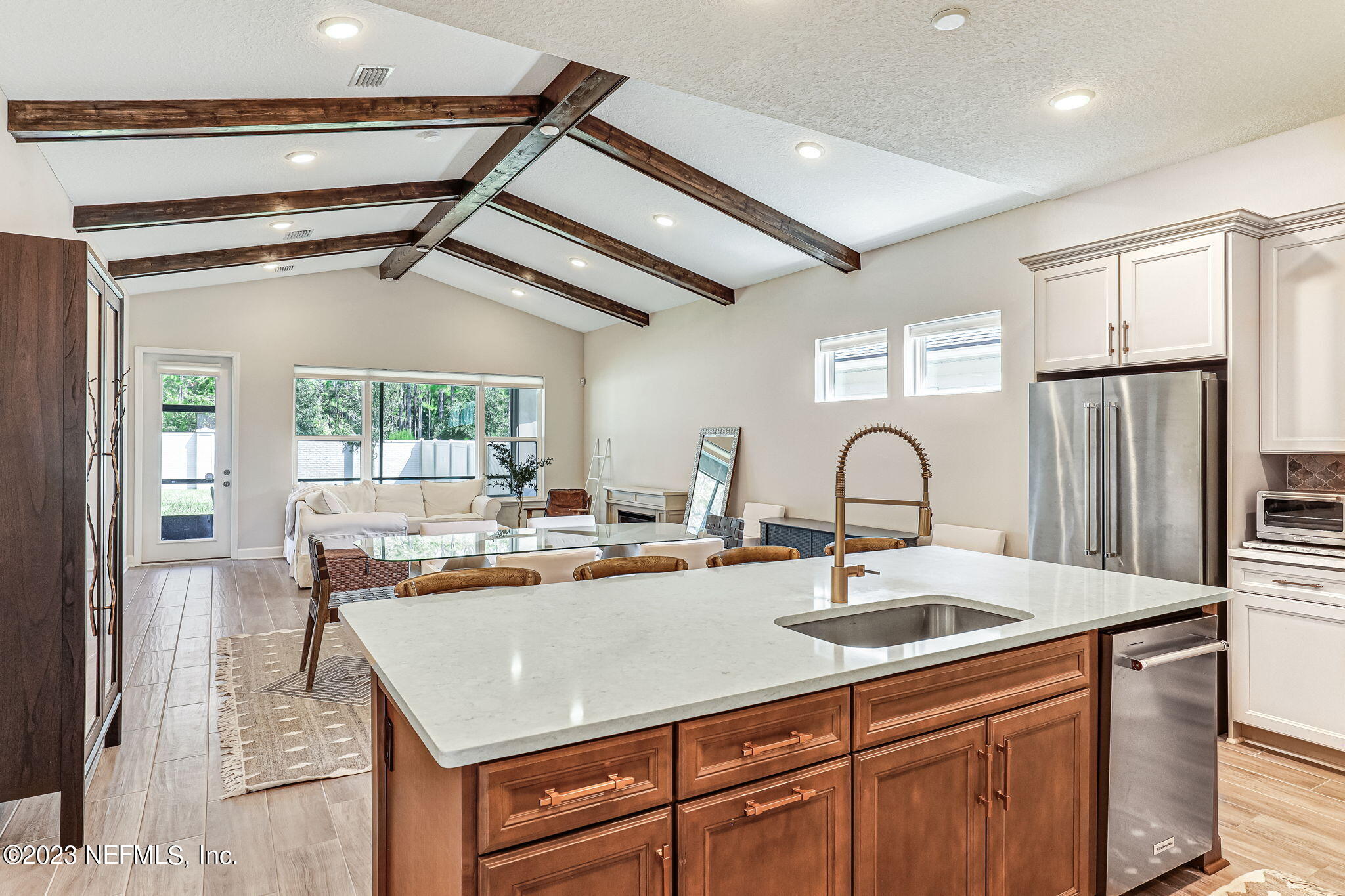 9863 Invention Lane Jacksonville, FL 32256 - Photo 20 of 56 a kitchen with kitchen island a sink appliances and a counter top space