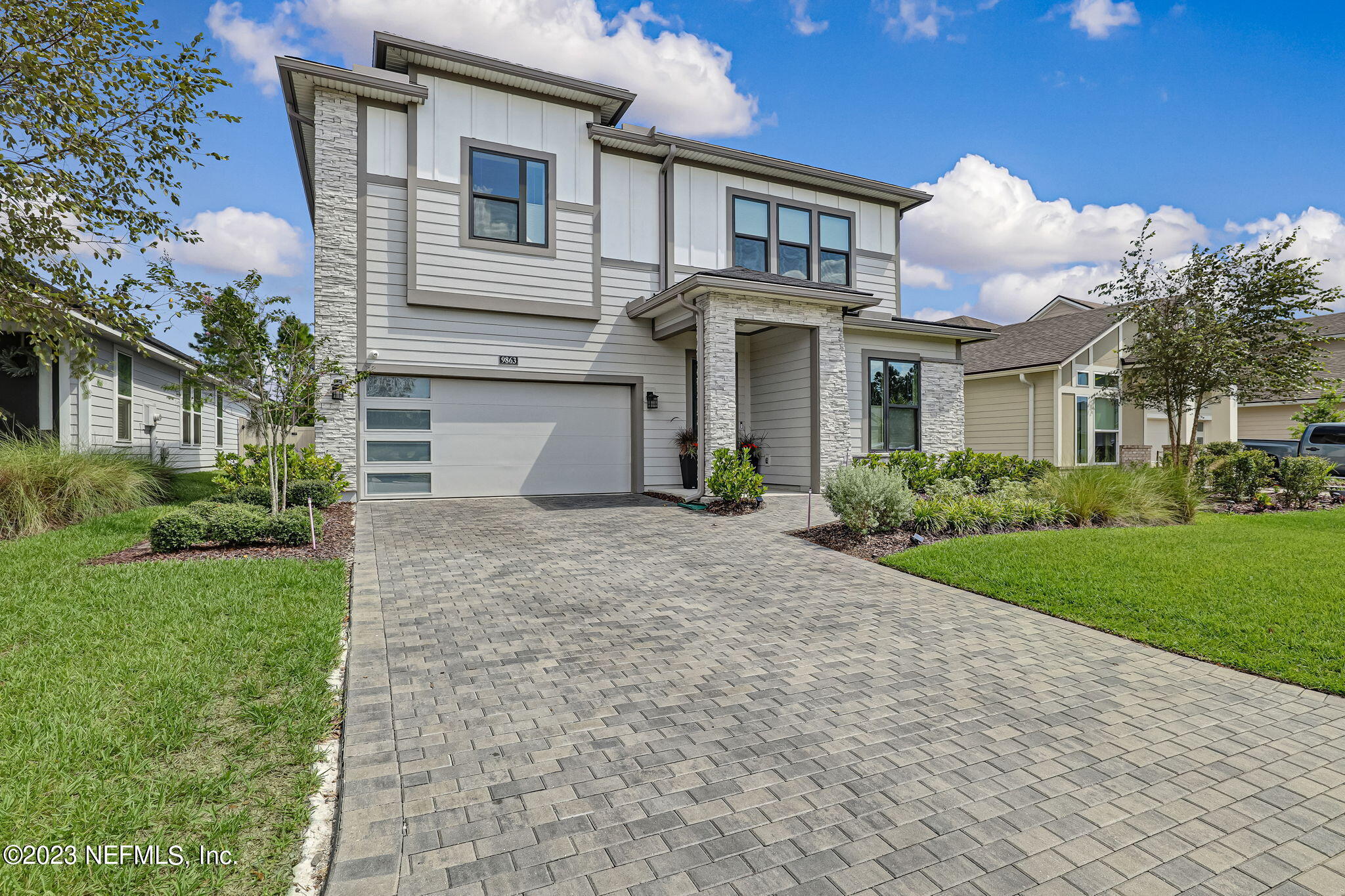 9863 Invention Lane Jacksonville, FL 32256 - Photo 2 of 56 a view of a white house with a large windows and a yard