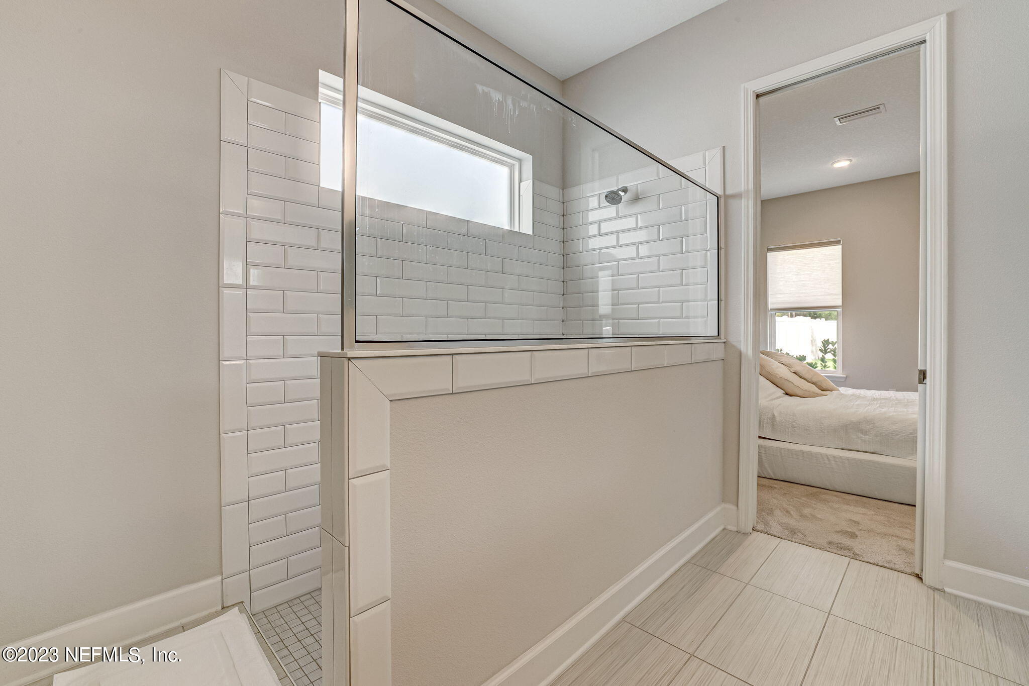 9863 Invention Lane Jacksonville, FL 32256 - Photo 27 of 56 a bathroom with a bathtub and a shower
