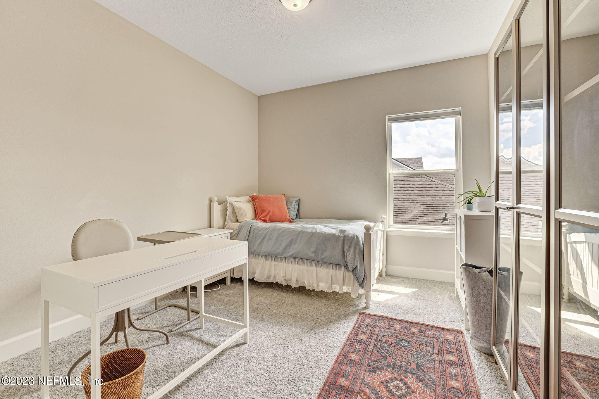 9863 Invention Lane Jacksonville, FL 32256 - Photo 35 of 56 a bedroom with a bed and a table in it