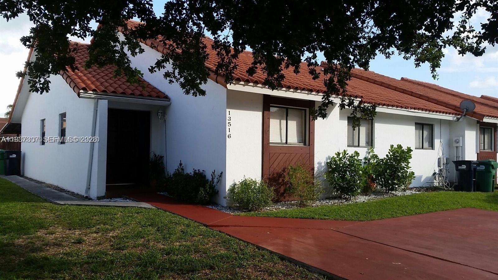 13516 Southwest 59th Lane Miami, FL 33183 - Photo 1 of 20 a front view of a house with garden