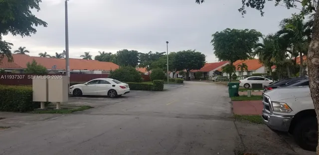 a view of a street with a cars park