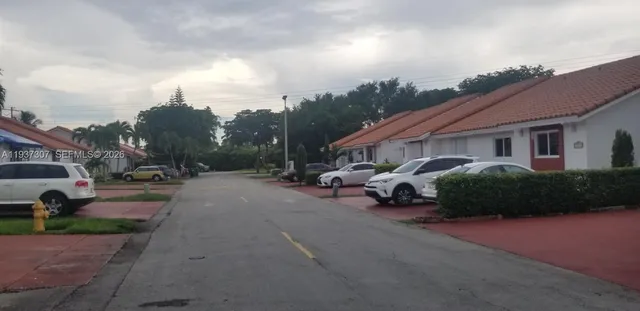 a view of a street with a cars parked
