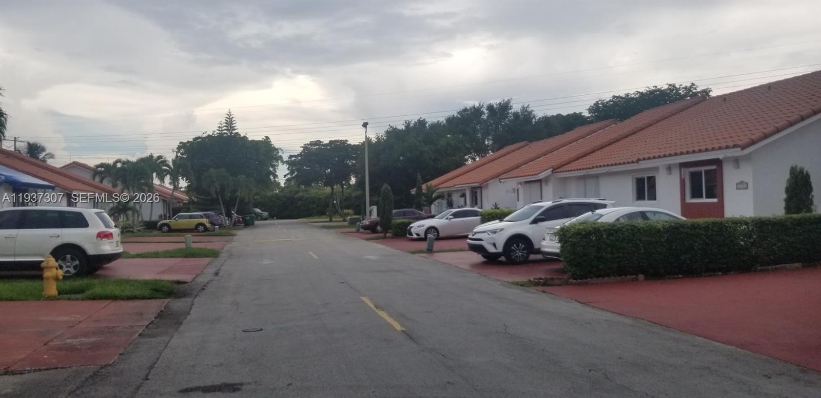 13516 Southwest 59th Lane Miami, FL 33183 - Photo 4 of 20 a view of a street with a cars parked