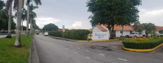a view of a town with palm trees
