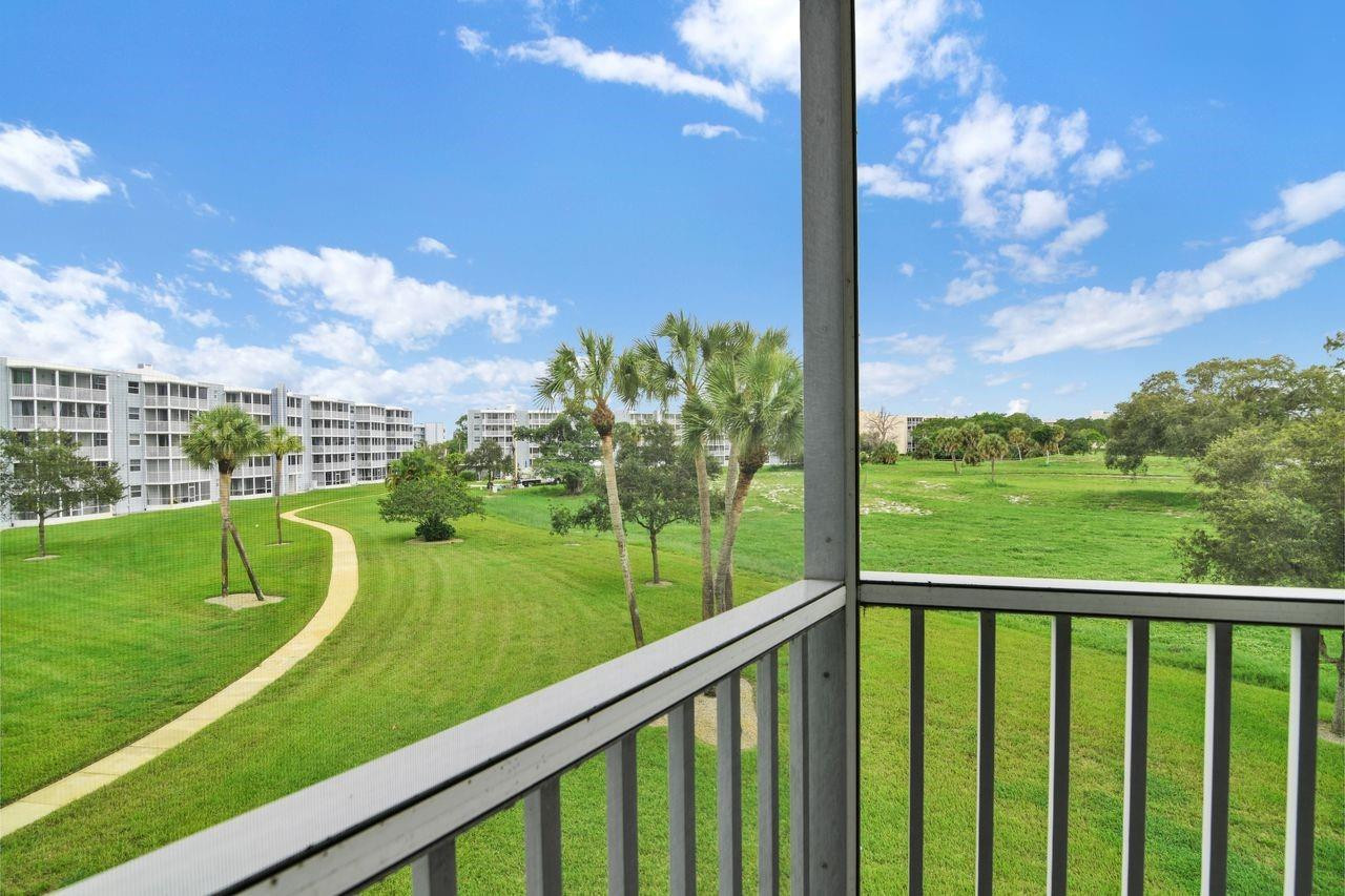250 Northwest 67th Street, Unit 322 Boca Raton, FL 33487 - Photo 12 of 15 a view of a garden and trees