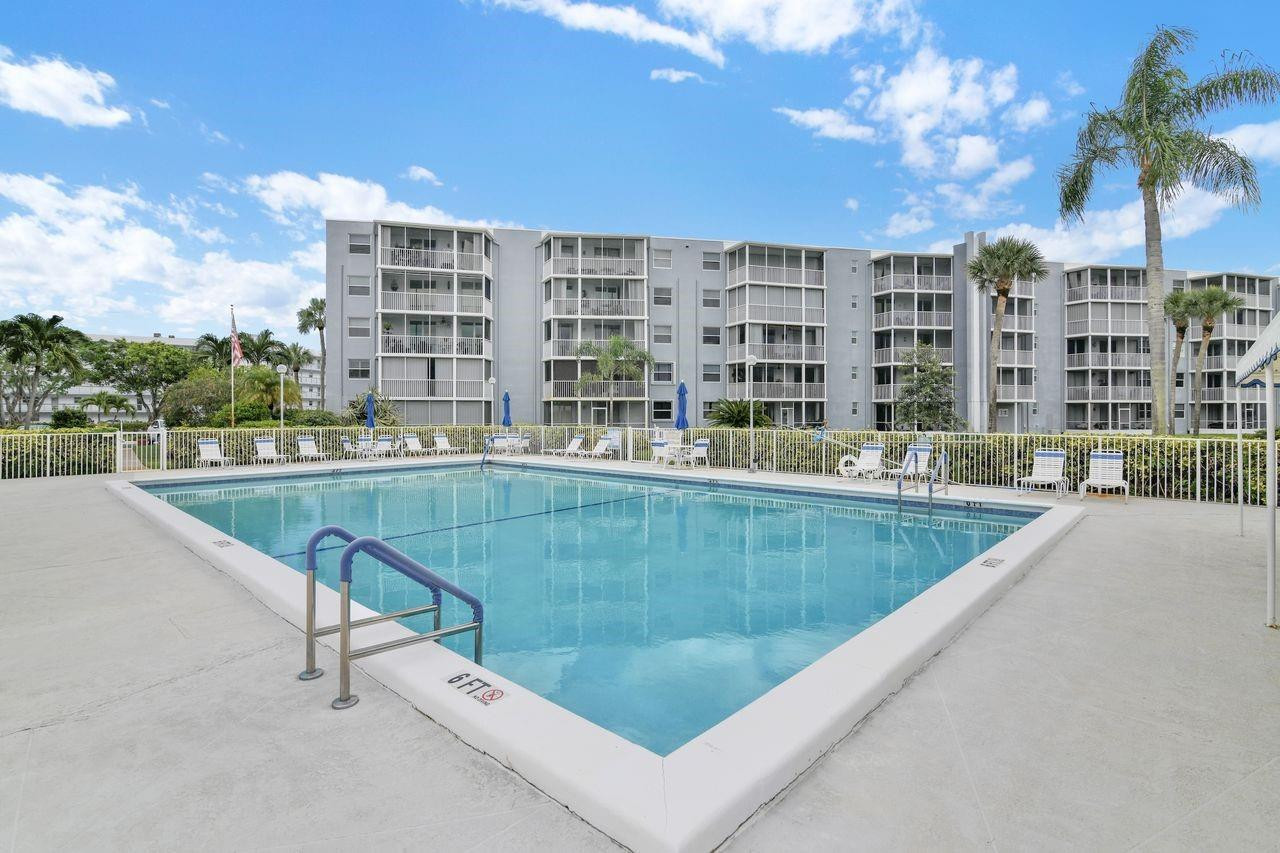 250 Northwest 67th Street, Unit 322 Boca Raton, FL 33487 - Photo 15 of 15 a view of swimming pool with outdoor seating and city view
