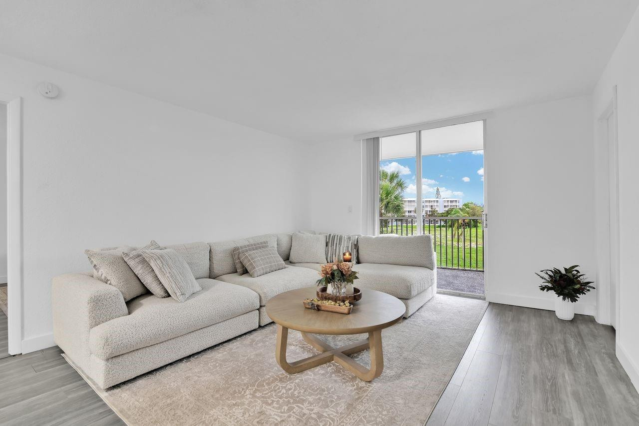 250 Northwest 67th Street, Unit 322 Boca Raton, FL 33487 - Photo 2 of 15 a living room with furniture and a large window