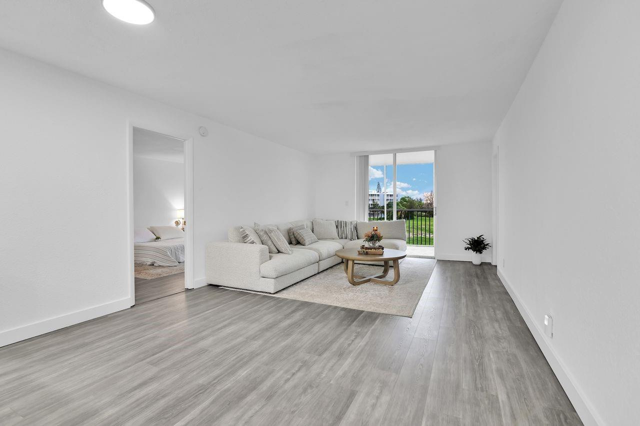 250 Northwest 67th Street, Unit 322 Boca Raton, FL 33487 - Photo 4 of 15 a living room with furniture and a window