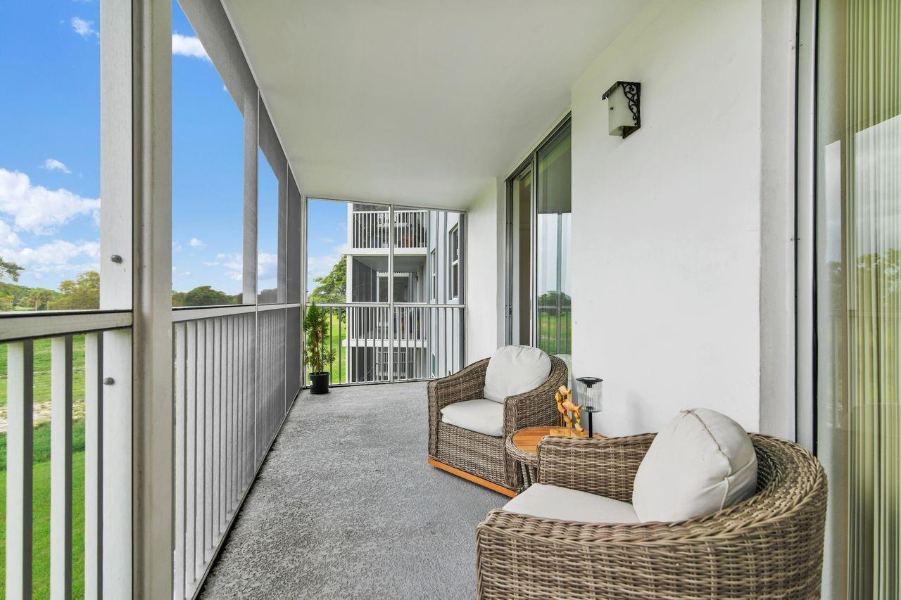 250 Northwest 67th Street, Unit 322 Boca Raton, FL 33487 - Photo 10 of 15 a living room with furniture and a window