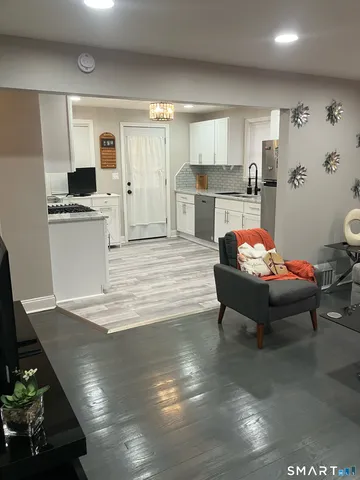 a living room with furniture and kitchen view