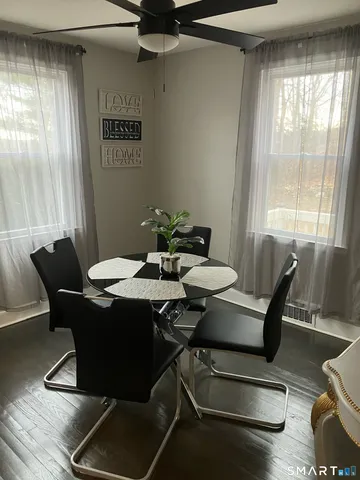 a view of a dining room with furniture and wooden floor